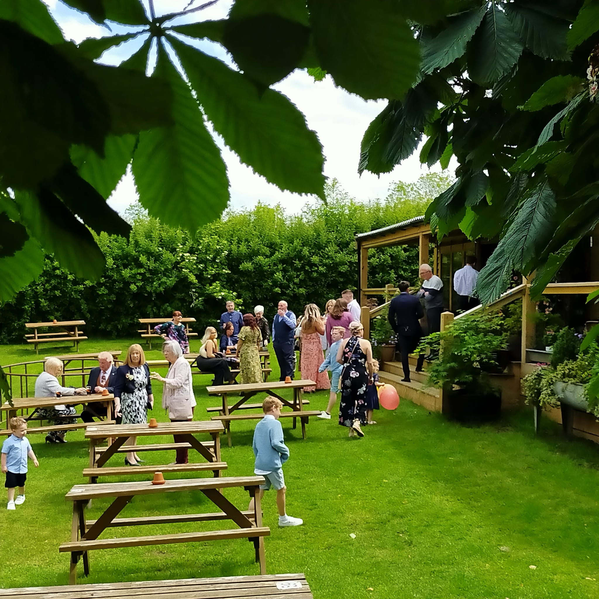 The Folly's garden with people enjoying themselves