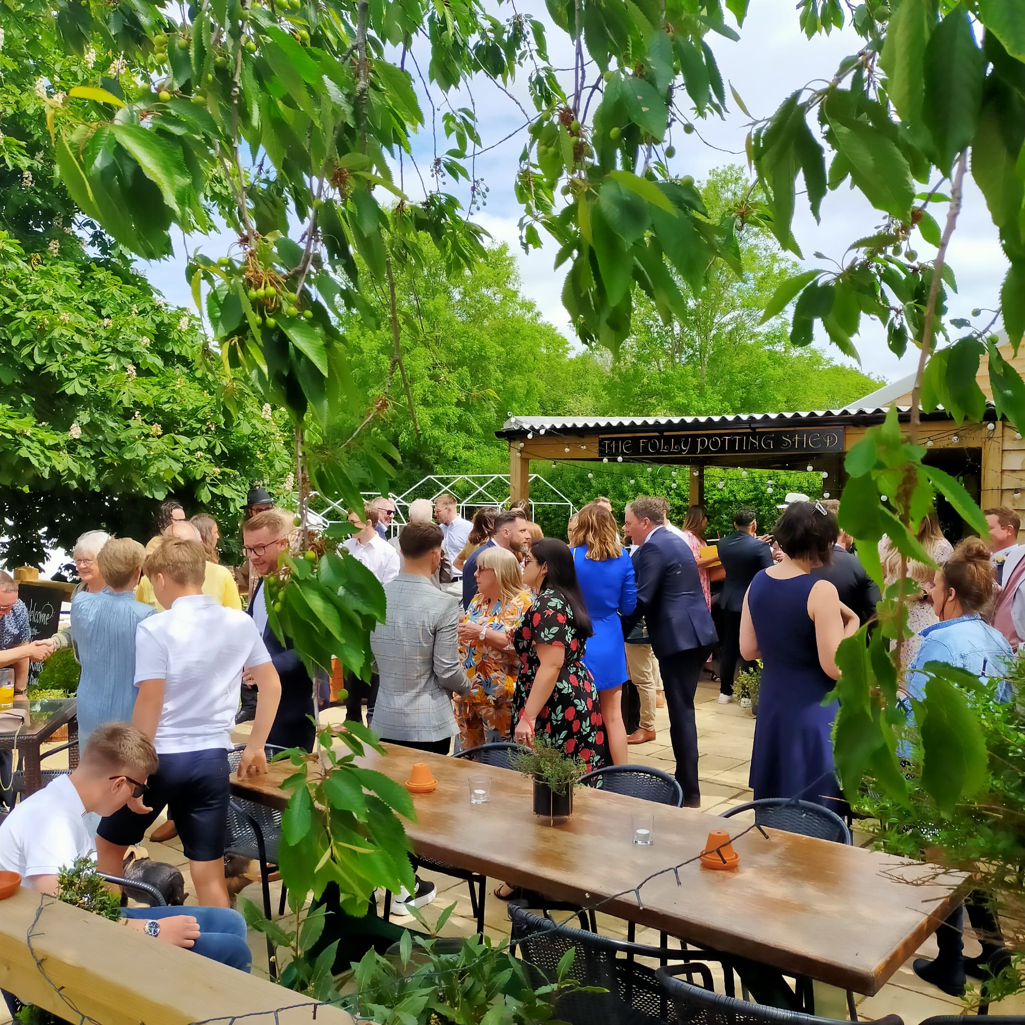 People gathering on the patio of the Potting Shed at the Folly Inn Napton