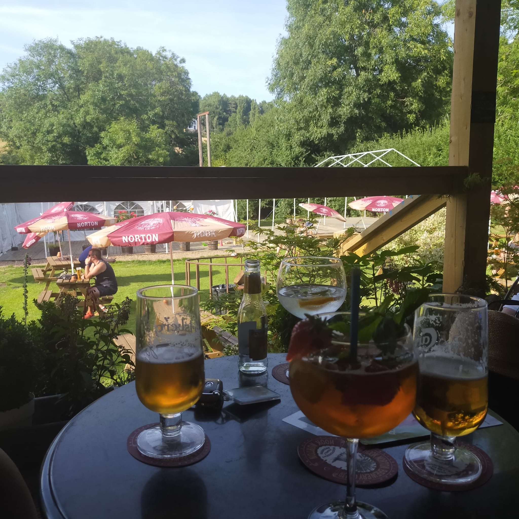 Potting Shed Patio with drinks on a table overlooking the Folly Garden