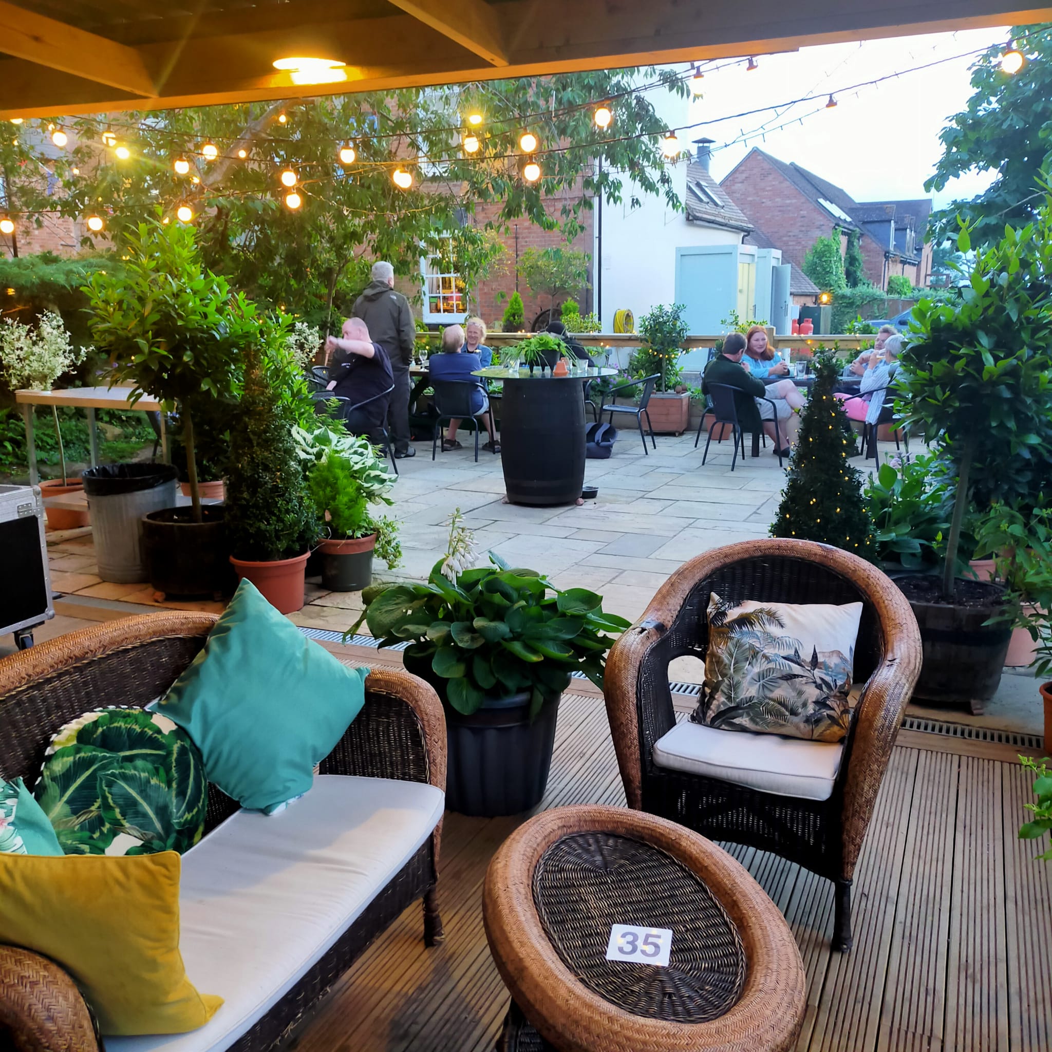 People gathering on the Patio of the Potting Shed
